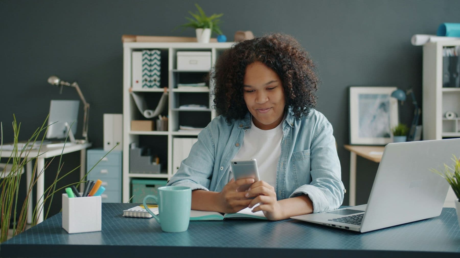 A lawyer working alone at her desk with a laptop and phone