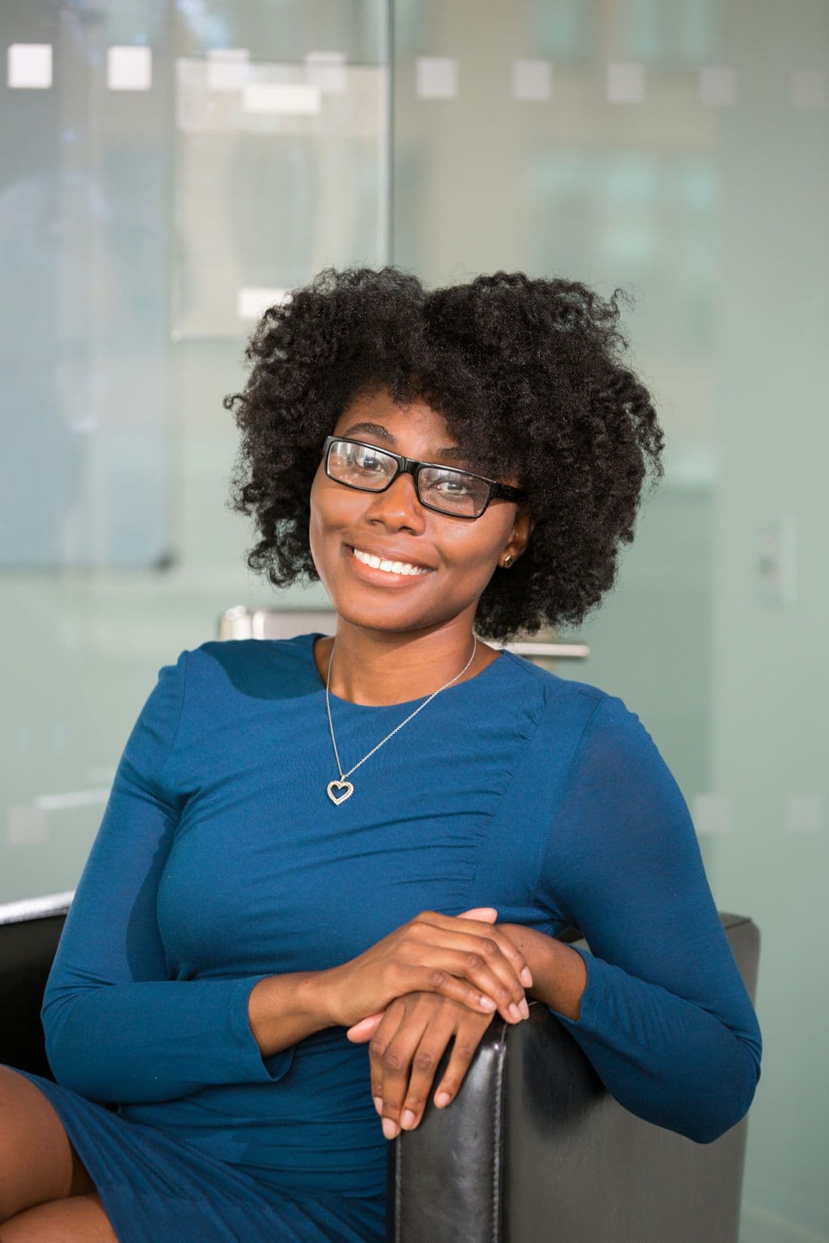 A smiling lawyer seated in her office
