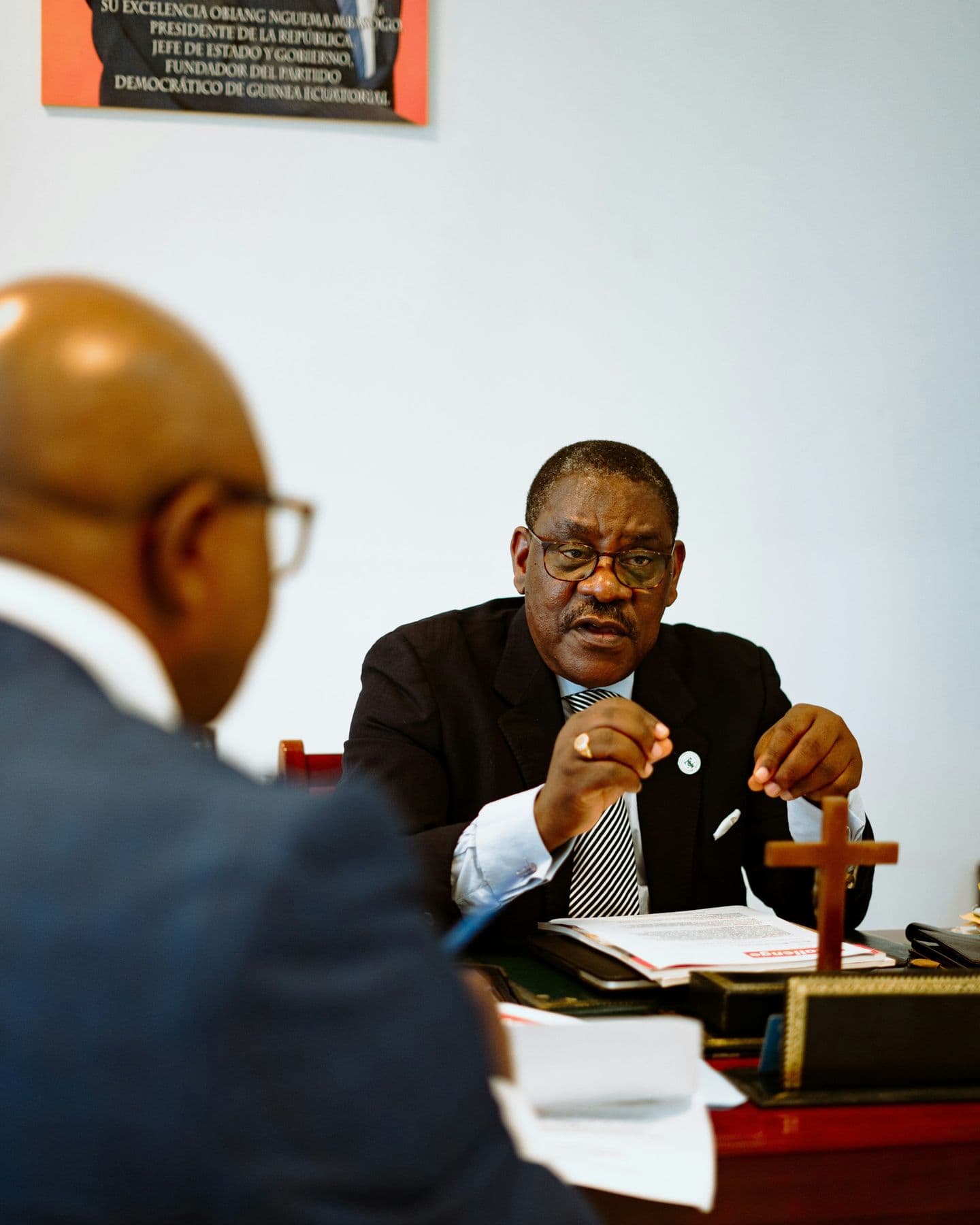 A senior lawyer in a meeting at his desk